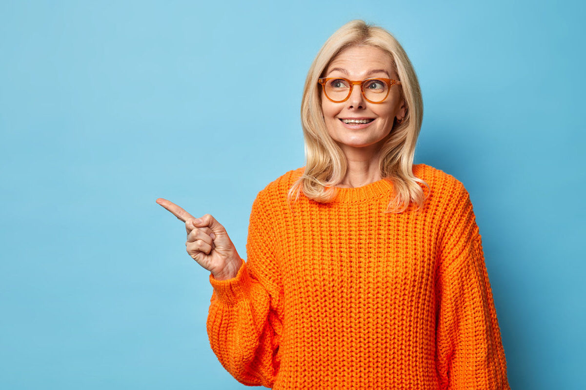 mature-woman-orange-sweater-glasses