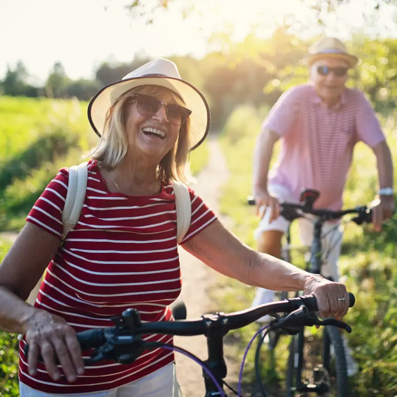 senior-couple-red-shirts-biking