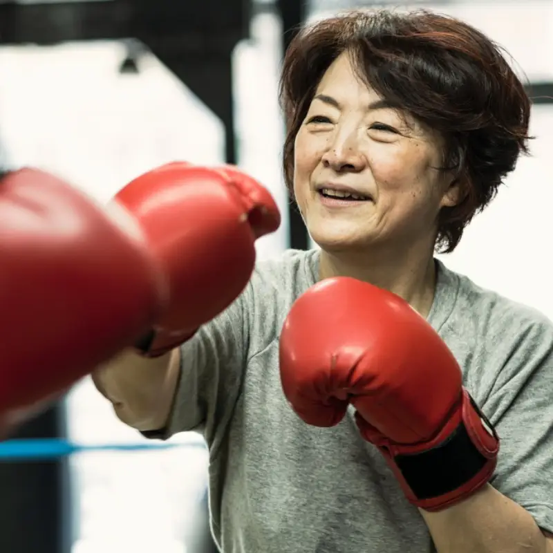 senior-woman-boxing-with-trainer