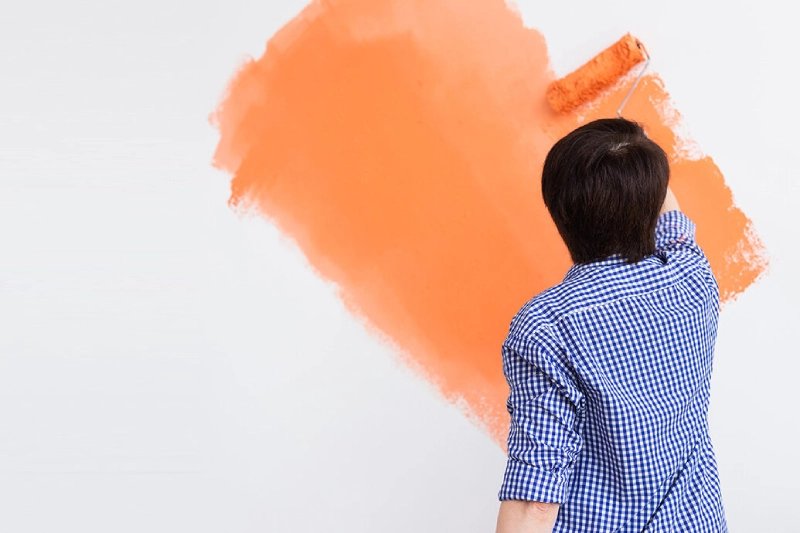 adult-painting-wall-orange