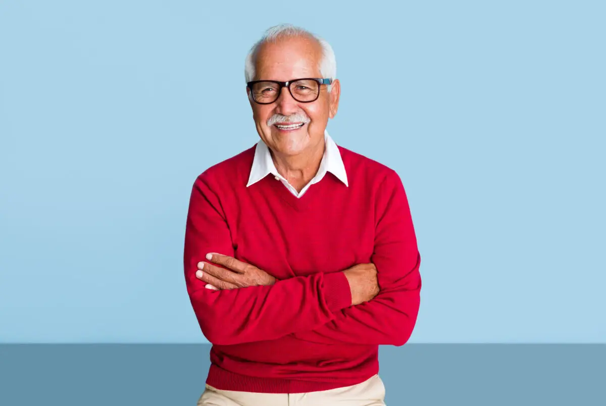 Benefits of a PrimaryCare Physician - hispanic-senior-man-red-sweater