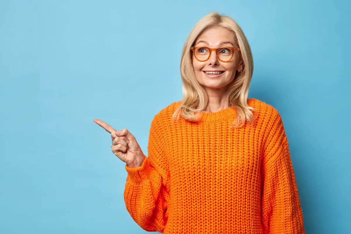 mature-woman-orange-sweater-glasses