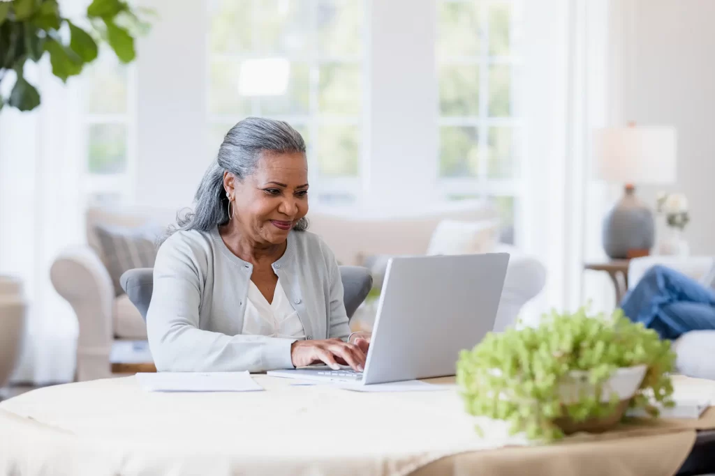 senior-woman-smiles-checking-computer