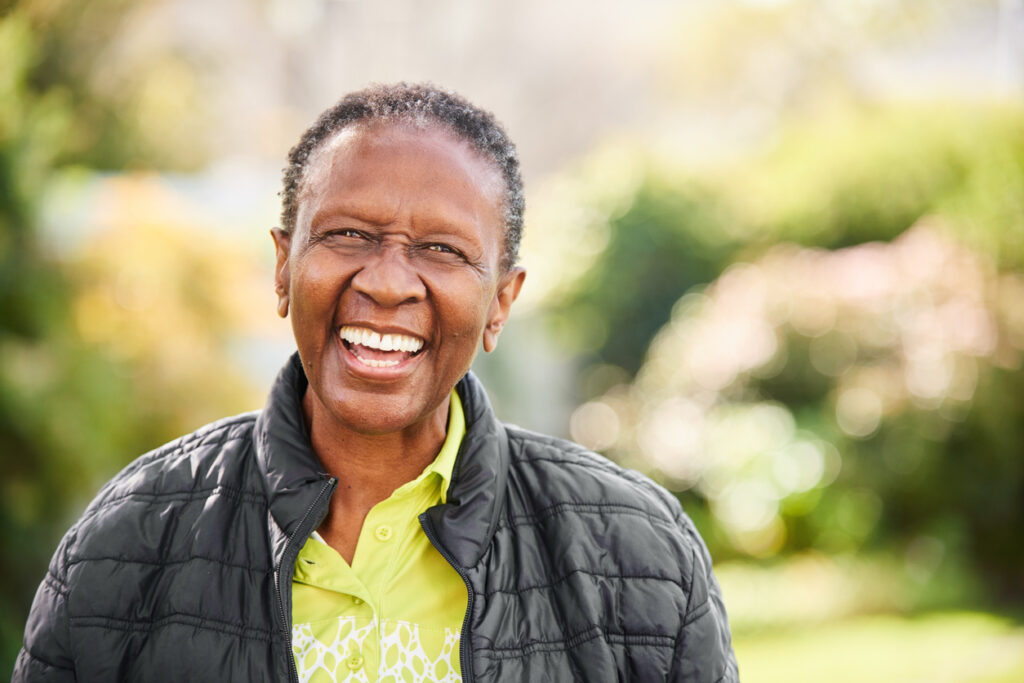 Medicare Advantage-woman-black-jacket-outdoors-smiling