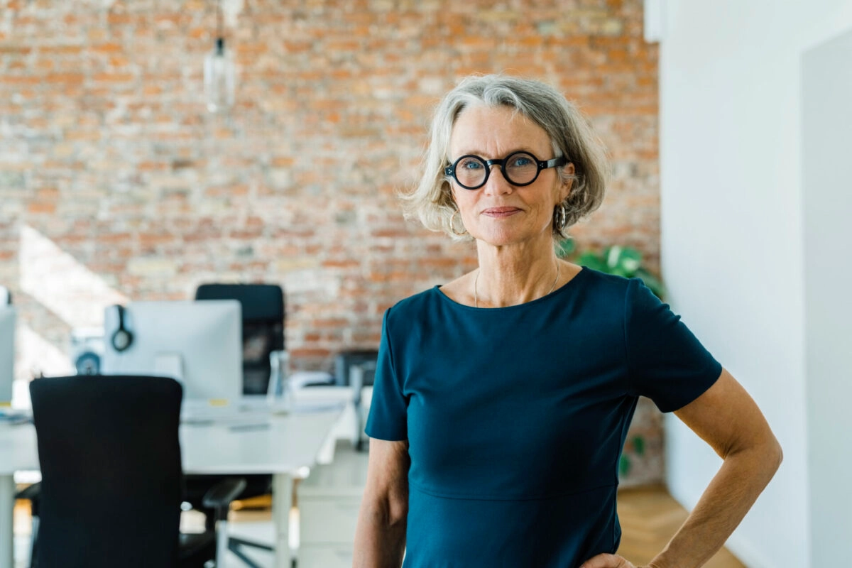 working-senior-woman-brick-wall