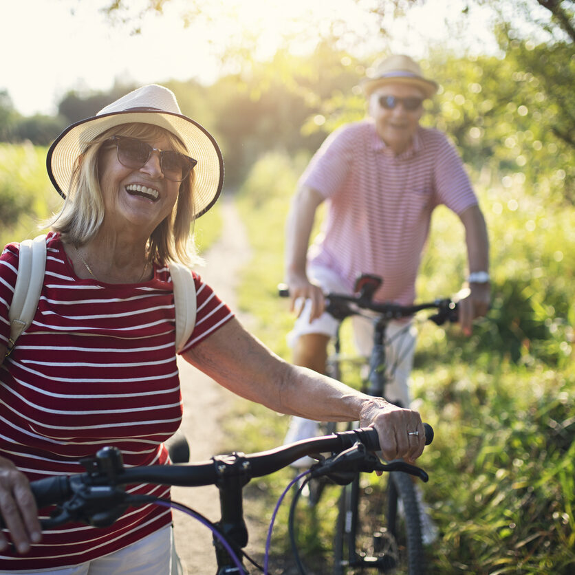 senior-couple-red-shirts-biking