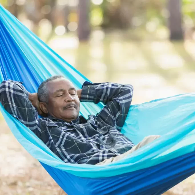 senior-man-resting-in-hammock-outdoors