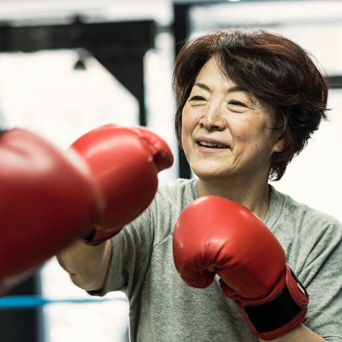 senior-woman-boxing-with-trainer